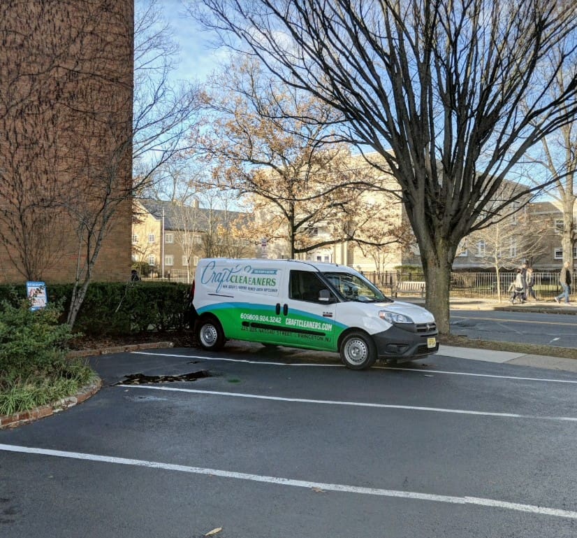 Craft Cleaners delivery van parked in Princeton, featuring the company logo, contact number, and website, highlighting convenient laundry pickup and delivery service.
